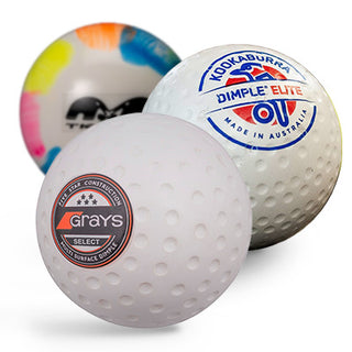 Three white hockey balls with logos on a white background